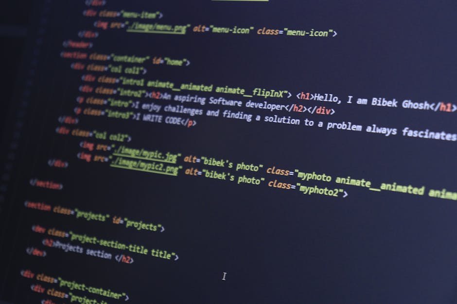 A photograph showing a close-up of a computer screen displaying lines of HTML code with syntax highlighting. The code includes tags such as <h1>, <div>, and <img>, with various colors indicating diffe